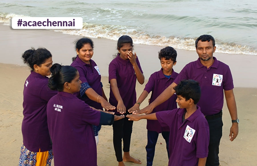 A group of ACAE Chennai volunteers on a beach.
