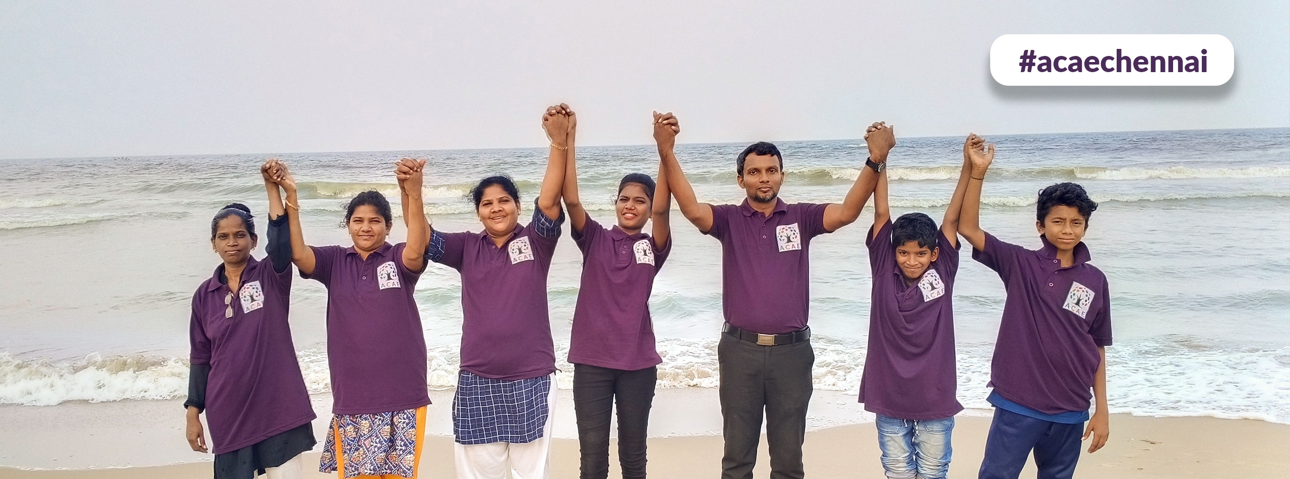 ACAE Chennai volunteers make a human chain on a beach.